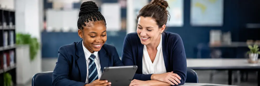 Teacher and learner reviewing an election on a tablet